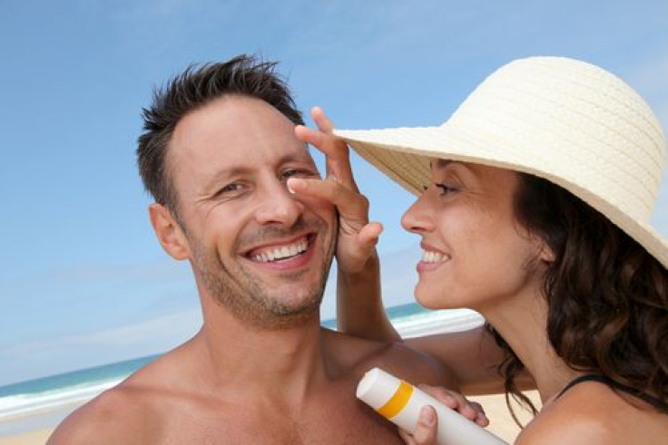 woman-putting-sunscreen-mans-nose