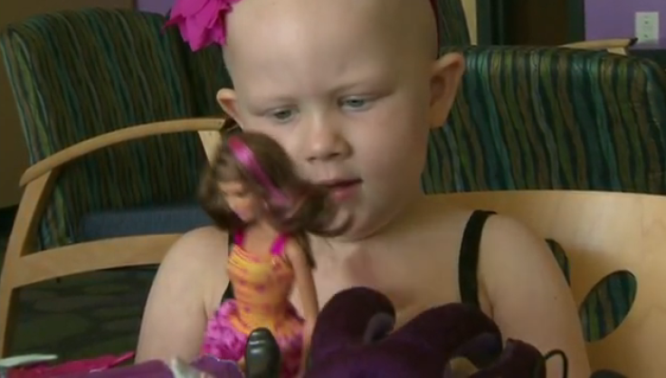 Grace plays with 'chemo Barbie'