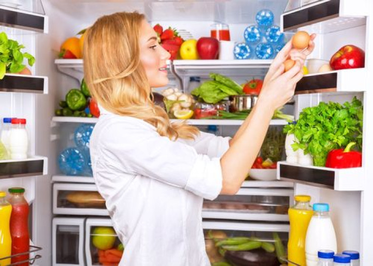 Woman getting eggs from refrigerator
