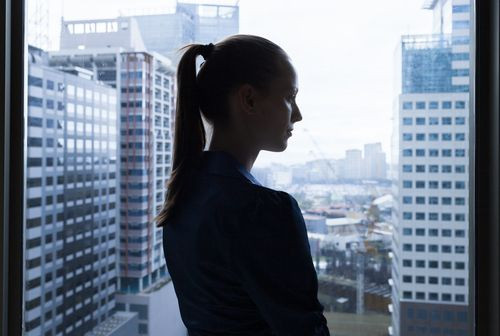 Business woman looking out window
