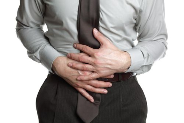 Businessman holding his stomach in pain