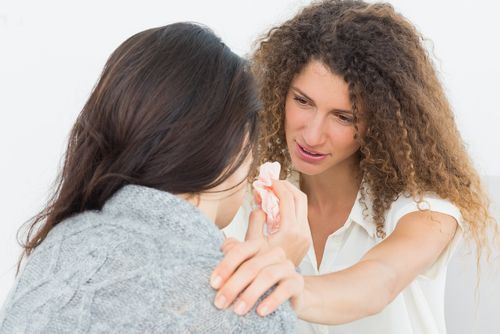 Therapist comforting upset patient at therapy session