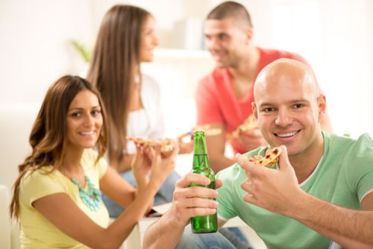 People eating, smiling, and drinking