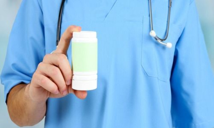 Doctor holds up prescription pill bottle