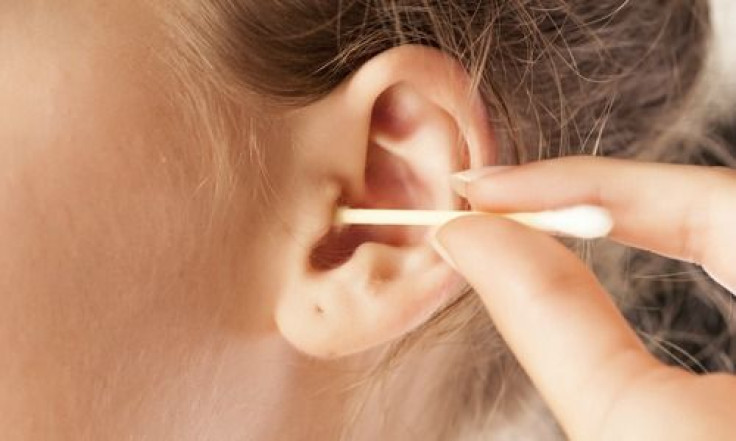 Woman cleaning her ear