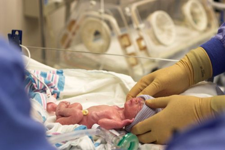 Preterm baby in incubator.