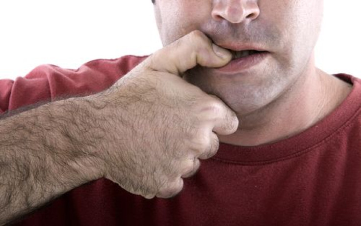 Man biting his thumb nail