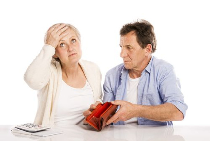 Couple with empty wallet discussing financial issues