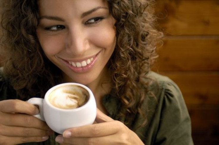 Woman smiling drinking cappuccino 