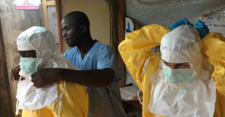 Ebola workers work to contain the virus