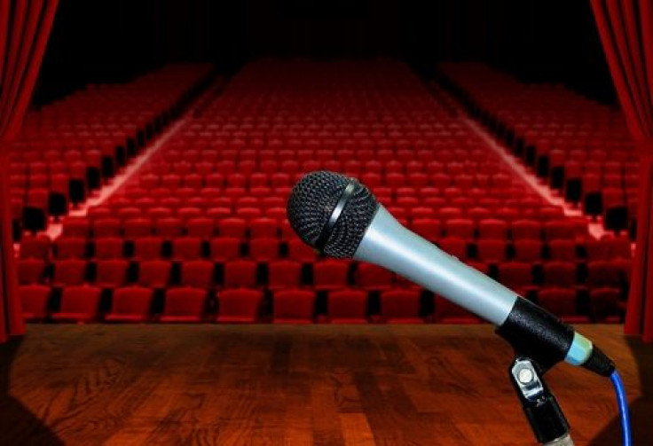Microphone on stage facing empty auditorium seats