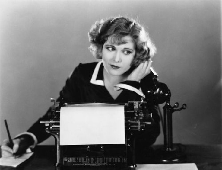 Businesswoman standing and waving in office