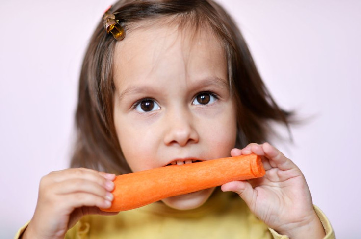 Kid Eating A Carrot