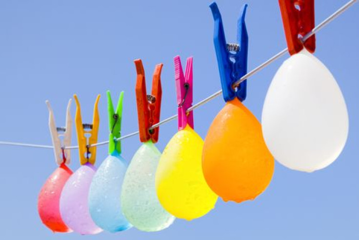 Balloons with water drops hanging on a clothesline 