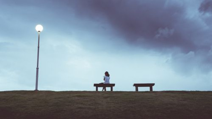 Woman sitting alone on a bench