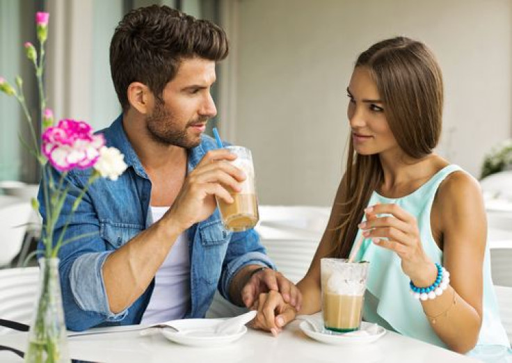 Couple talking and drinking coffee