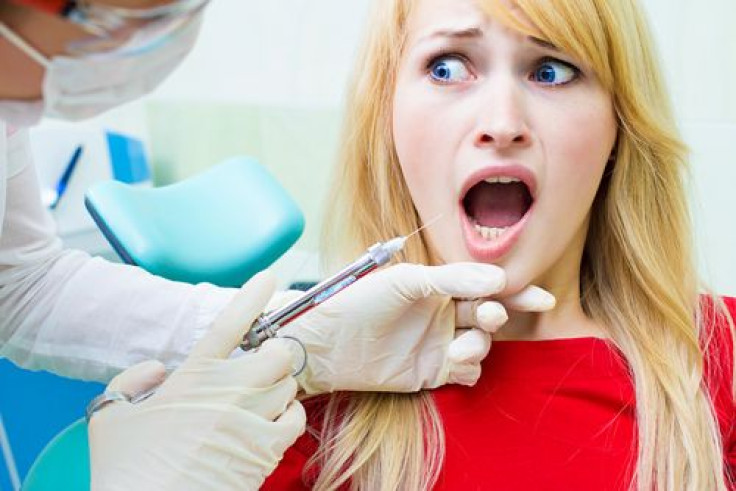 Terrified patient sitting in chair at dentist