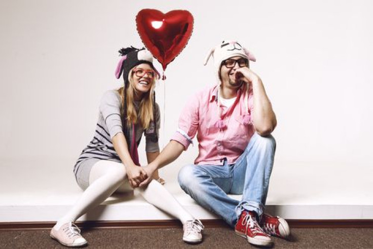 Couple holding hands with heart balloon 