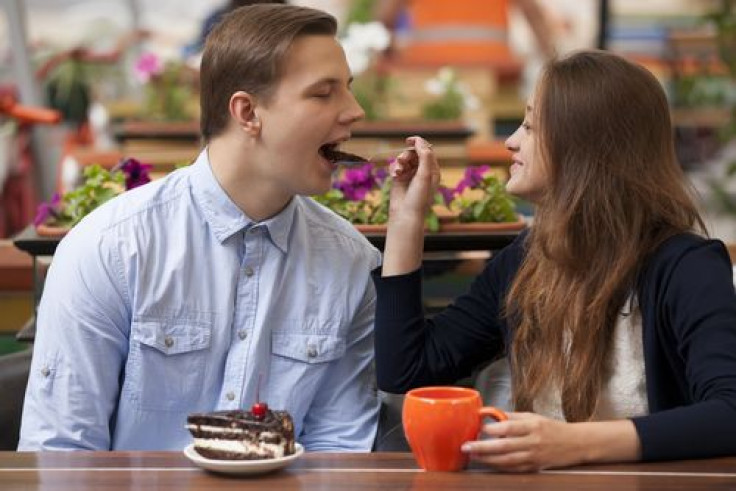 Woman sharing food with man