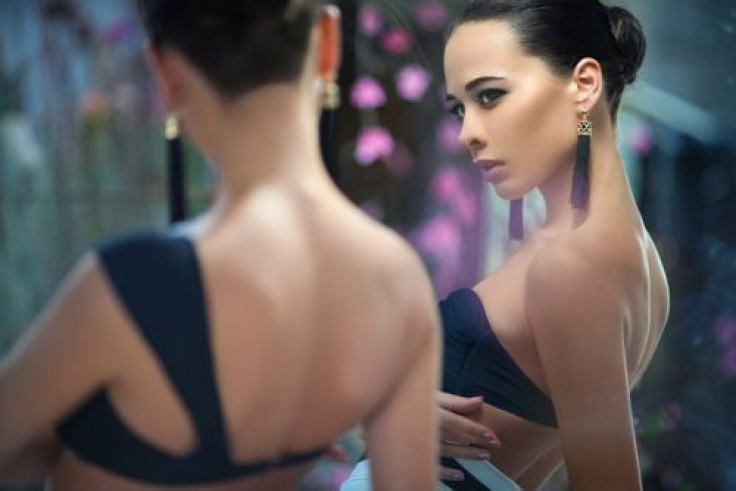 Woman looking at herself in the mirror