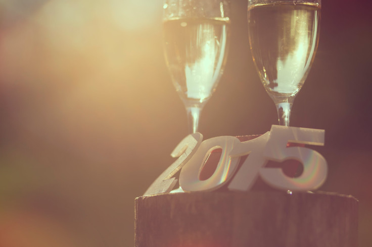 Champagne glasses with cardboard numbers 2015 and lens flare effect