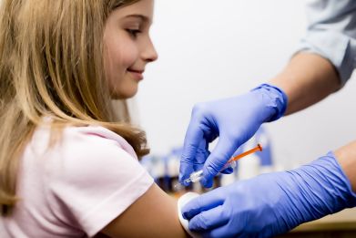 A girl gets vaccinated.