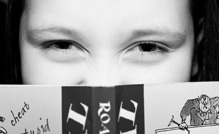 Young girl reading Roald Dahl