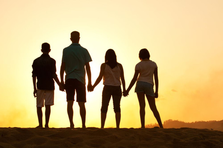 Group of four holding hands