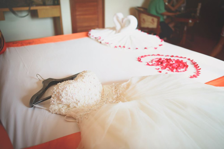 Wedding dress in room with rose petals, wedding decoration, Rose of Bouquet