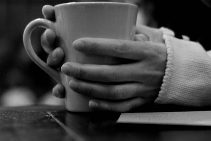 Hands holding cup of coffee