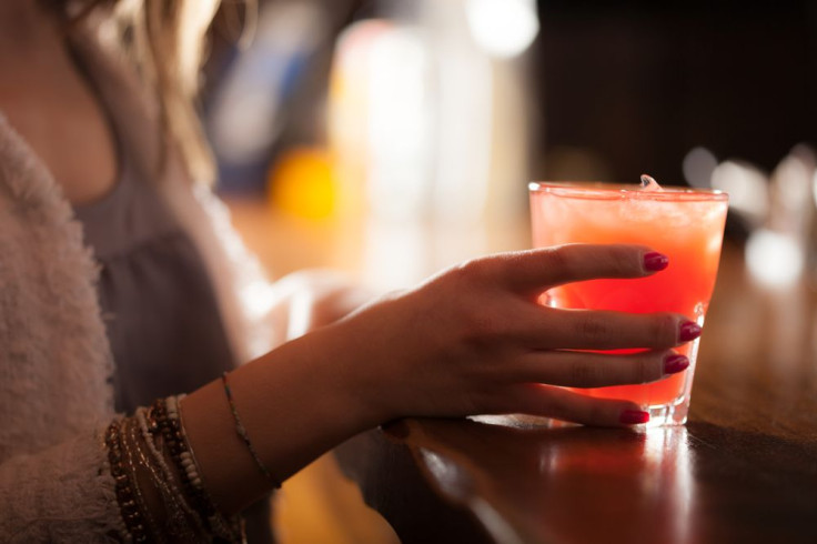 Woman holding a cocktail glass at bar