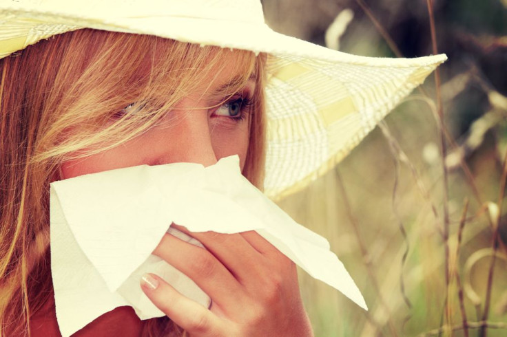 Woman with tissue covering nose