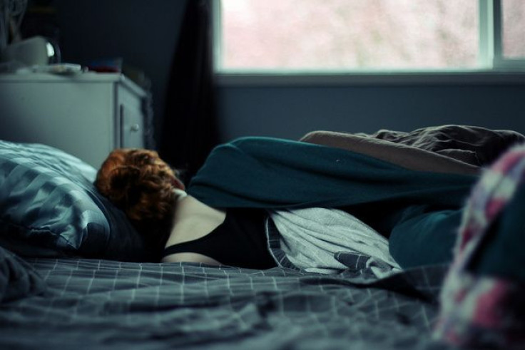 Woman in bed facing the window