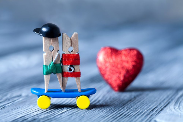 Clothespins are romantic couple on skateboard 