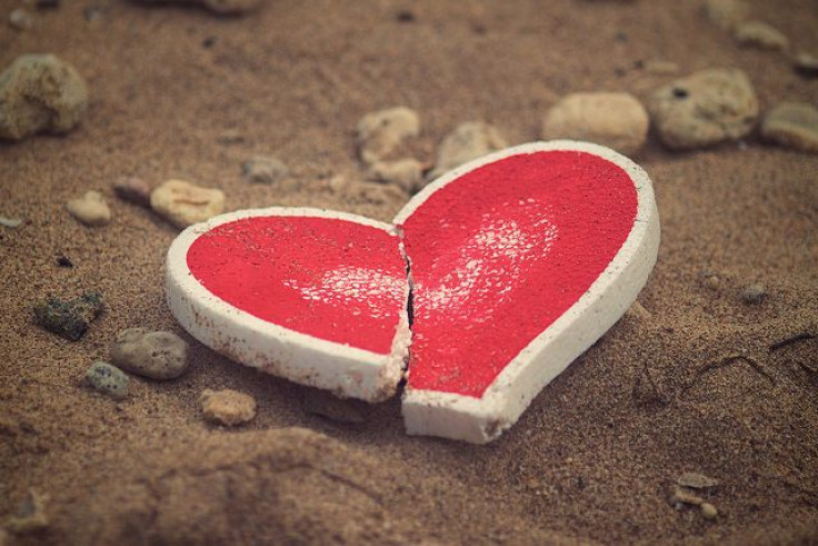 Broken heart in sand