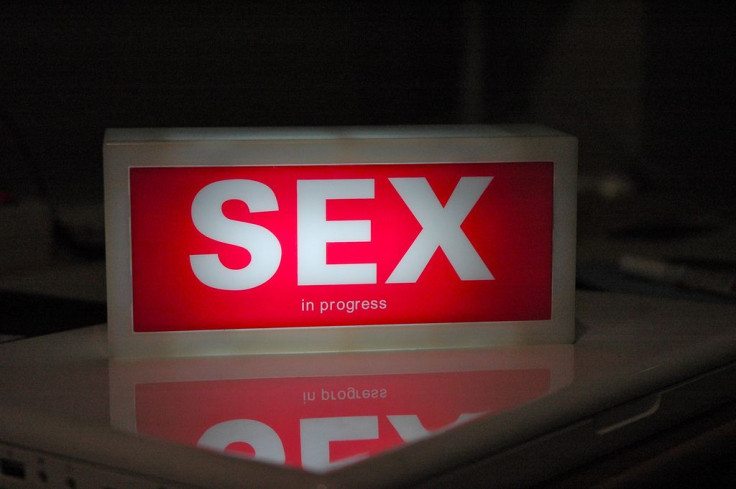 "Sex in progress" sign on laptop