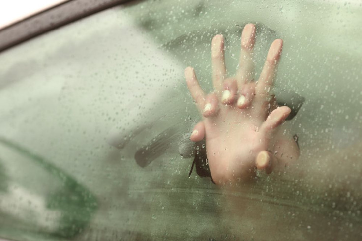 Hands on foggy car window