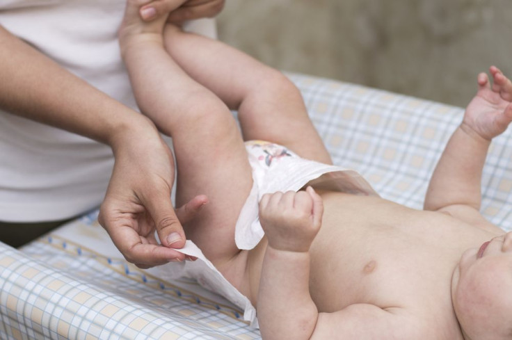 Mom changing baby's diaper