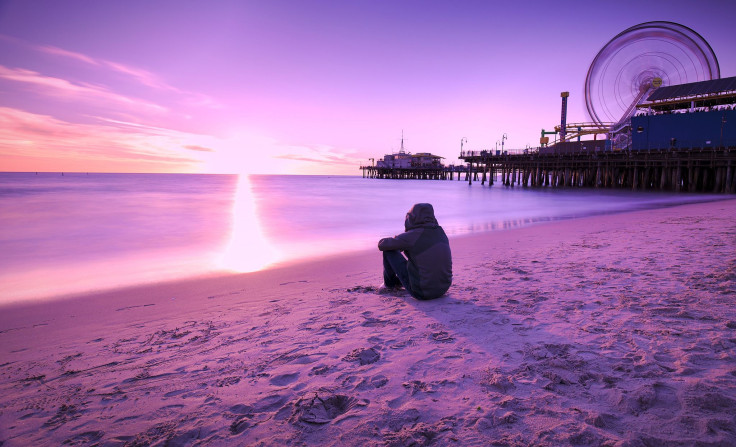 Man sitting on beach alone