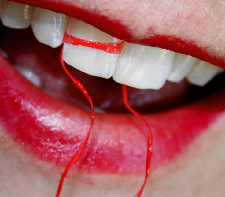 Woman flossing teeth