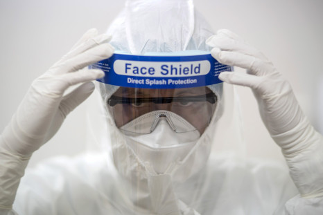A member of medical personnel put on a face shield during a drill as part of preparations in the event of a Middle East Respiratory Syndrome (MERS) outbreak, at a private hospital in Bangkok, Thailand, June 24, 2015.