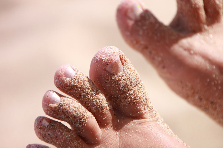 Feet covered with sand