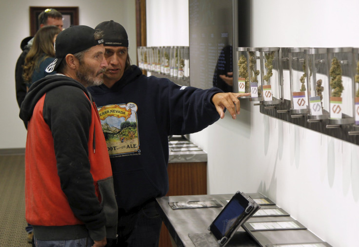 Two men browse samples at Shango Cannabis shop.