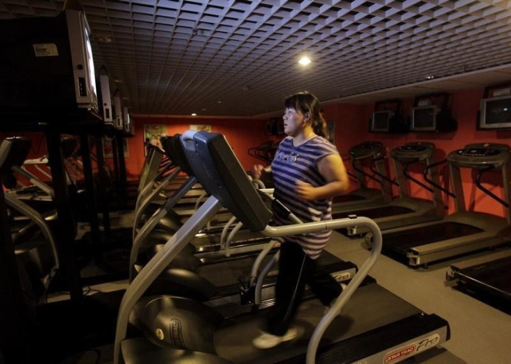 A woman runs on a treadmill. 