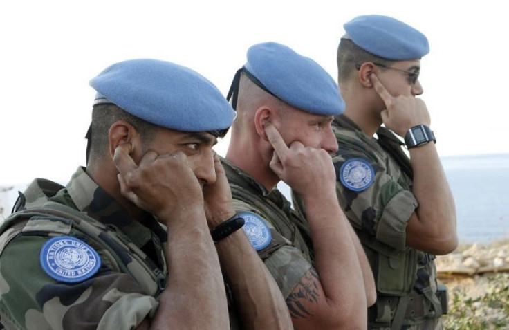 French U.N. peacekeepers cover their ears during a live training exercise.