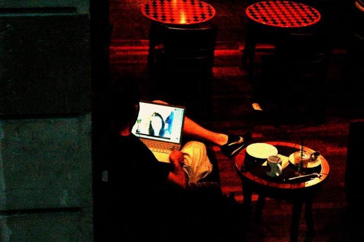 Man on computer in cafe