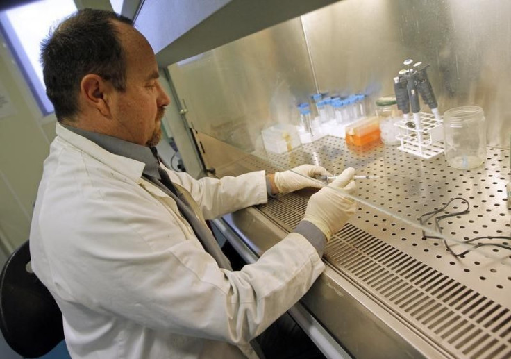 Erwann Loret prepares samples of a vaccine.