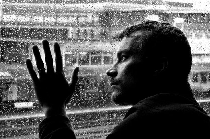 Man looking out window