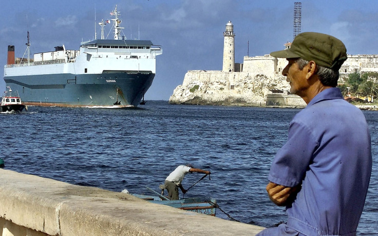 A man stands by a Havana shipping dock. 