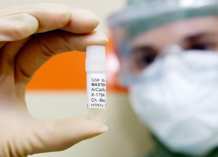 A technician holds a H1N1 virus sample. 